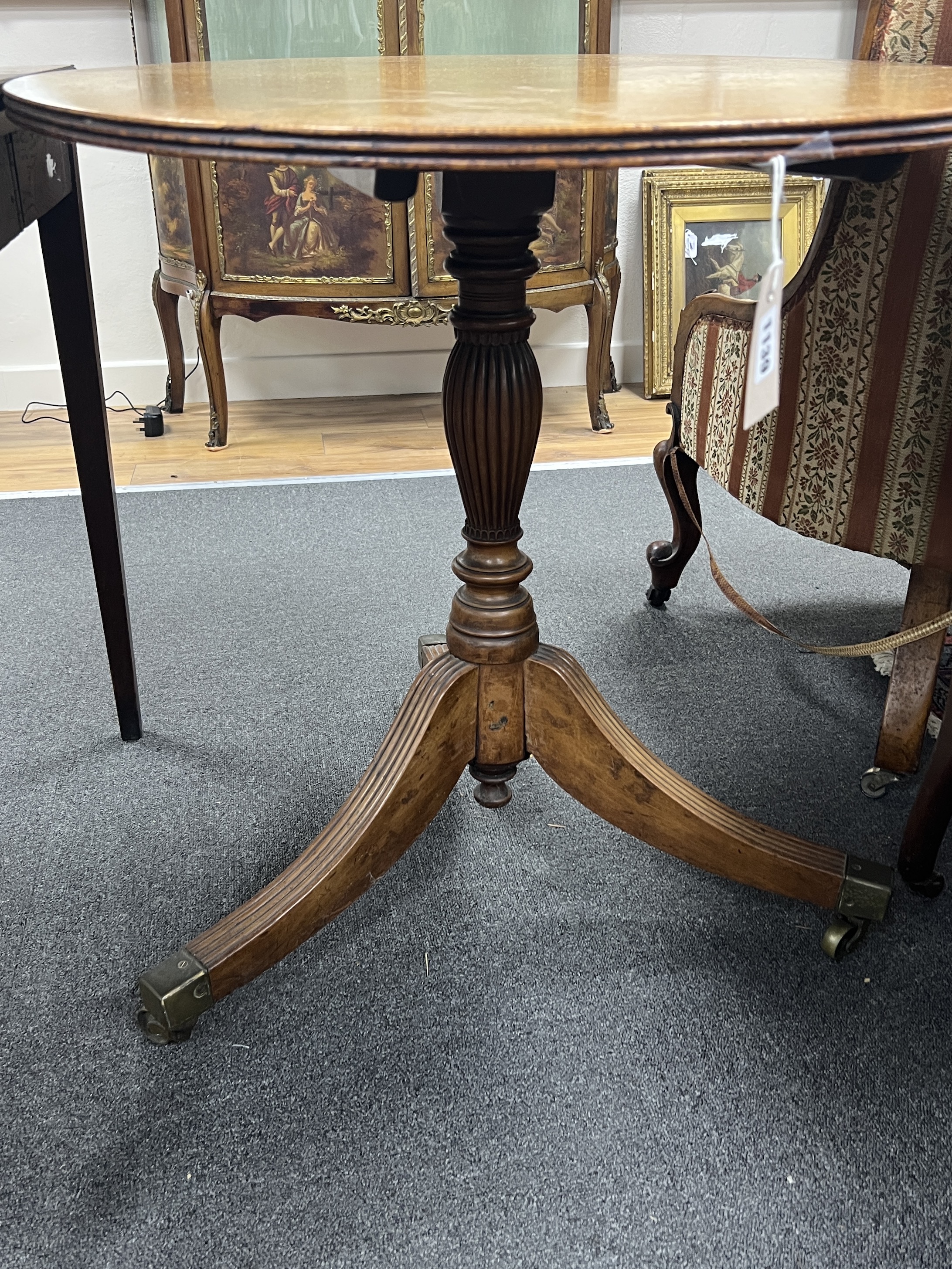 A George III bird's eye maple oval tilt top tea table, width 90cm, depth 68cm, height 71cm